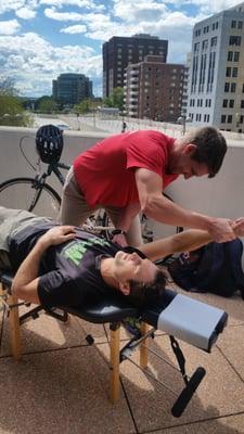 Dr. Caleb Halulko of River Of Life Traverse City adjusts his patient.