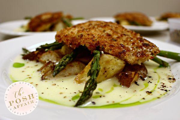 Parmesan-Crusted Chicken w/ Lemon Butter Sauce served alongside Yukon Gold & Redskin Potatoes and Roasted Asparagus