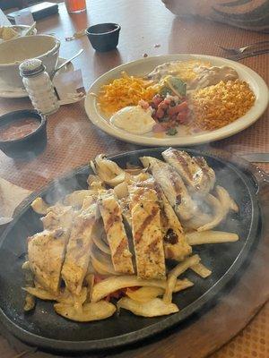 Lunch portion Chicken Fajitas with the fixing and side of flour tortillas.