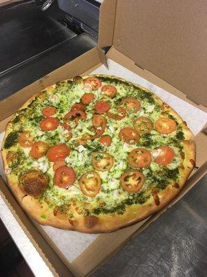 Gamberi and pesto pizza. Shrimp, tomatoes and pesto sauce