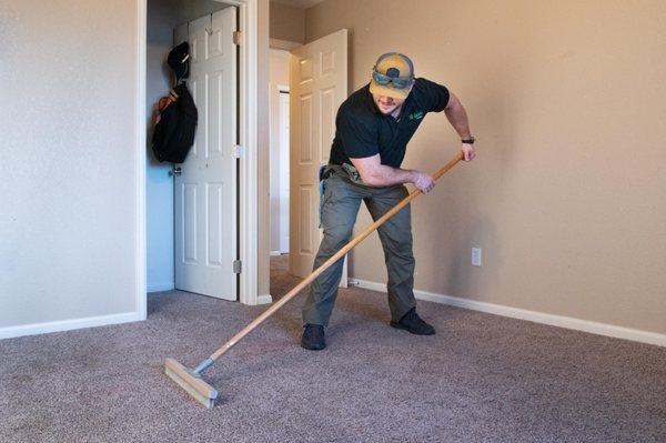 Step 1: Dry extraction begins with a vigorous raking to loosen debris from carpet fibers.