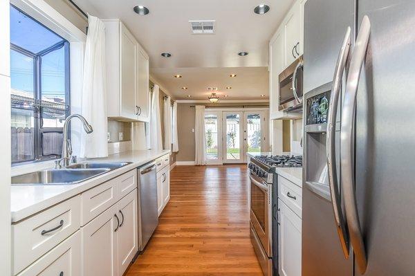 We gutted the kitchen and installed all new cabinets, counters, appliances and continued the hardwood floors into the kitchen.