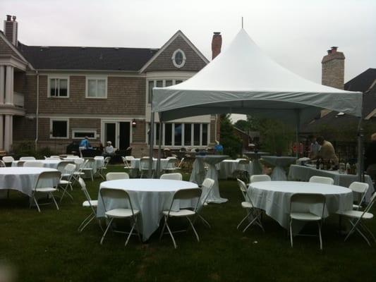 15x15 pinnacle frame tent with round tables, linens and white resin folding chairs