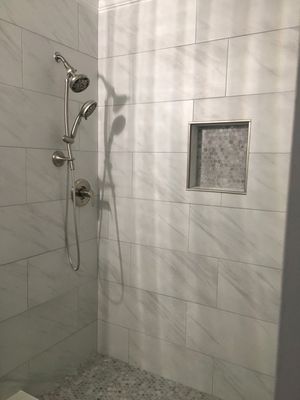 They built the shower head taller for my son who is growing every day and needed the height. Pardon the diagonal shadow lines.