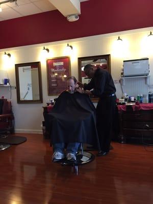 My dad getting a haircut from Jurrell. He is a really nice guy and my dad always likes his haircut