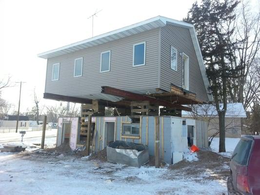 Raising a home to build up the foundation to keep it above water table.