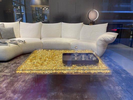 Beautiful setup - the sofa, the coffee table with gold flakes, the light in the back, everything is gorgeous!