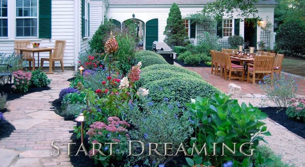 An outdoor living area with all the elements of great design - stone, brick and landscaping.