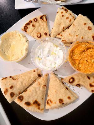 Pita sampler with tzatziki sauce, hummus, and spicy red pepper spread