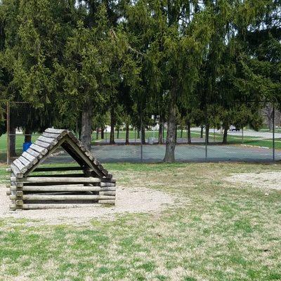 fort and small parking area inside the tree border