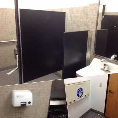 Functional men's bathroom with baby change station.