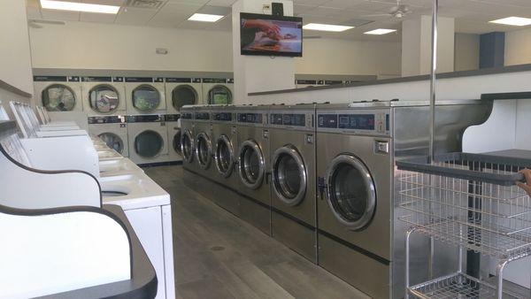 Modern and Welcoming Laundromat Design.  Spacious and Efficient, Comfortable seating, and Accessibility.