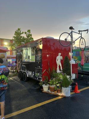 Here's the Pastaccini food truck, there's plenty of picnic tables with umbrellas close by, look for the bicycle to find us