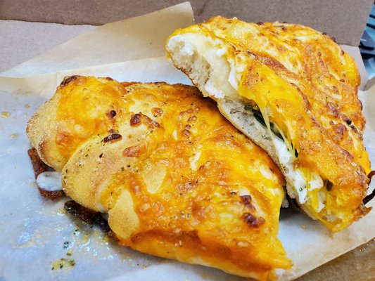 Spinach and feta cheesy bread broke in half.