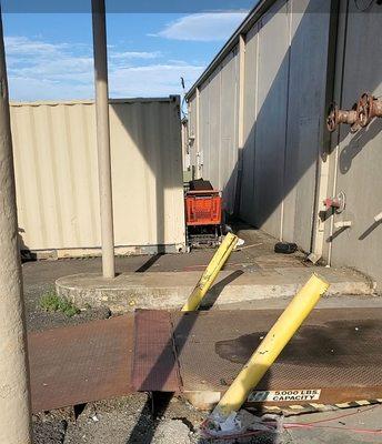 Poles ripped out of walls back of receiving also no safety rails