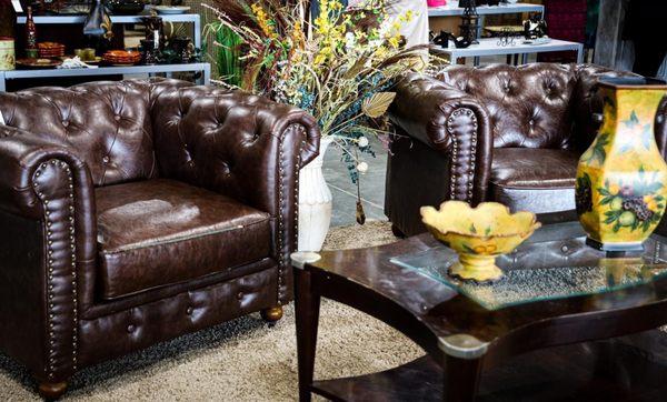 Brown leather club chairs.