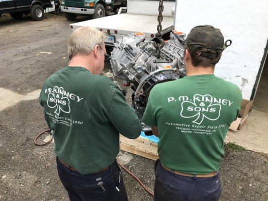 Pat Kinney & Son (Casey Kinney) prepare a new Diesel engine for installation.