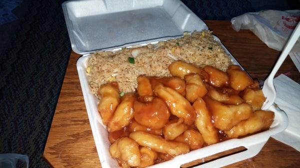 Dinner portion of take-out Orange chicken and shrimp fried rice.