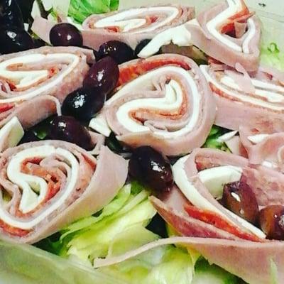 Italian Antipasto, made with ham, giardinari, salami, pepperoni, fresh mozzarella and kalamata olives over mixed greens.