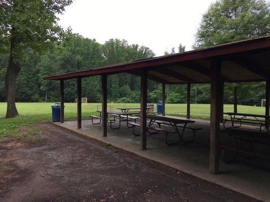 Pavilion with charcoal grills central to soccer field, playgrounds approx 100ft from parking lot.