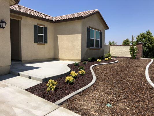 Front concrete court yard.  With lava rock planter.