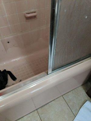 Bathtub needs chalking all around. Bottom of tub at floor, chalking. Bath tiles in tub need grout.