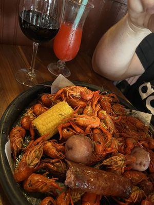 Crawfish, sausage, potato, corn, Hurricane drink, red wine