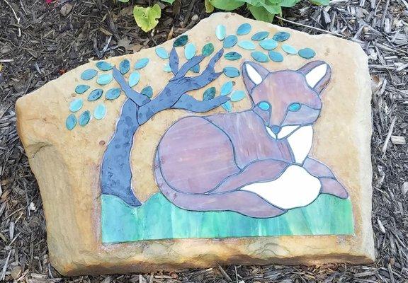 Fox lounging on a rock.  These garden rocks can be customized for your garden.