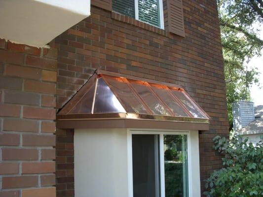 Standing seam copper roof installed on a bay window.