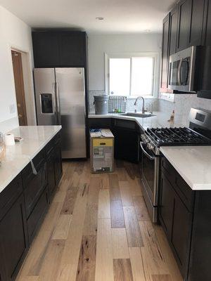 Black Shaker kitchen cabinets with Quartz counter tops and tile backsplash.