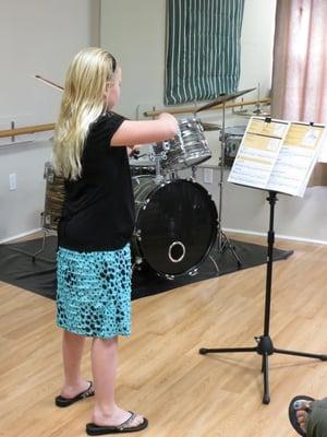 A violin student warming up for her recital.