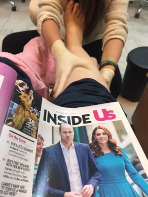 Reading a magazine and getting a relaxing pedicure!