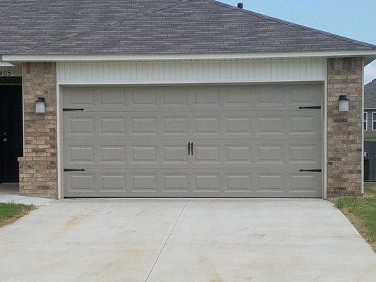 16x7 steel on steel garage door installed with decorative hardware.