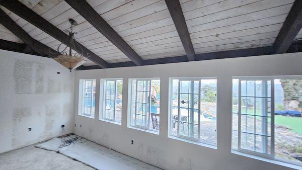 The workmanship really stands out in the living room with the windows and walls installed, taped and textured.