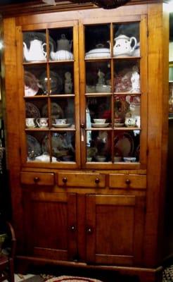 early 19th century curly maple corner cupboard, three drawers, bracket feet, 16 panes, walnut secondary wood