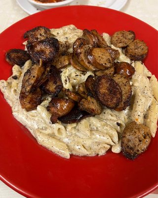 Sausage in Alfredo over pasta