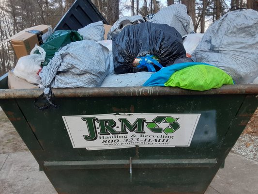 Overloaded, broken dumpster