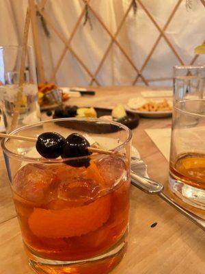 Old fashioned and snacks in the back inside of our rooftop yurt. Fun!