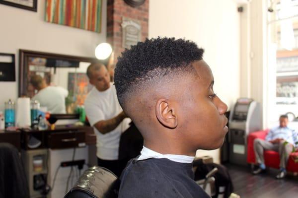 bald fade with the curl sponge on top.