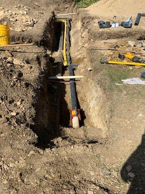 Adding future gas line to new water main.