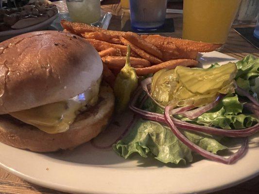 American classic cheese burger and sweet potato fries.