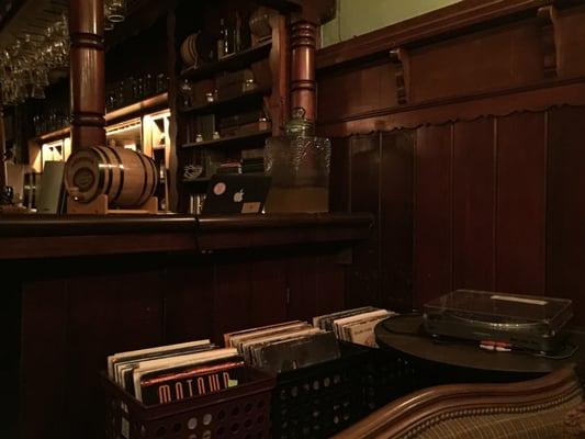 An impressive vinyl collection sits next to the bar. Darker panels at the back corner of the bar is where a secret tunnel to the beach was.