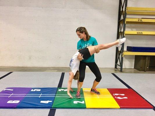 Coach Ashley teaching proper backhandspring technique.