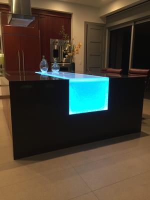 Glass LED-lit island inlay creates a beautiful, modern space to entertain and dine.