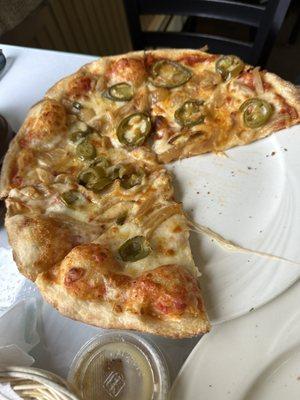 Crispy pizza with jalapeños and onions