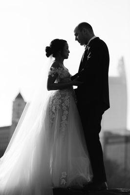 Couple with Atlanta Skyline in Piedmont Park on their wedding day.