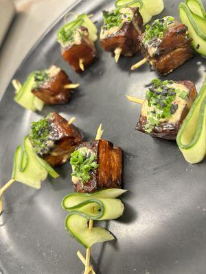 Pork belly skewers with a chili garlic aioli and black sesame seeds