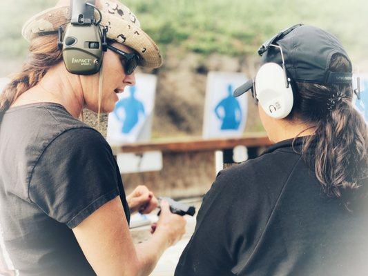 Michelle working with a student in Basic Firearm Use and Safety Class. (CCW)