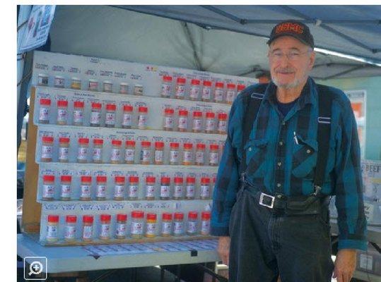 Ray Templeton standing next to a display of his Spices and Seasonings.