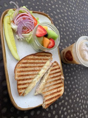 Swiss and turkey panini with a side of fruit and a sugar free caramel macchiato